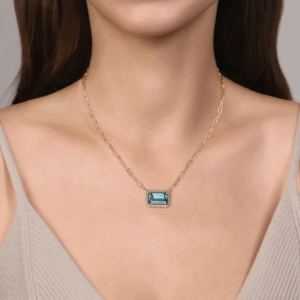 14K Yellow Gold East-West Pendant with 10.52ct Emerald Cut Blue Topaz & .48ctw Diamond Halo 17